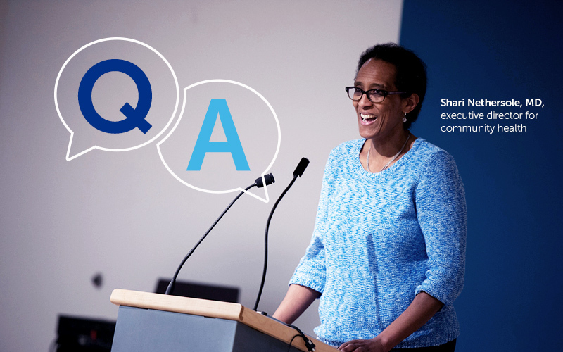 Dr. Shari Nethersole, executive director for community health, stands at a podium answering questions during COVID-19.