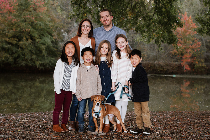 Steven, who has an anorectal malformation, poses with his parents, three sisters, brother, and their dog.