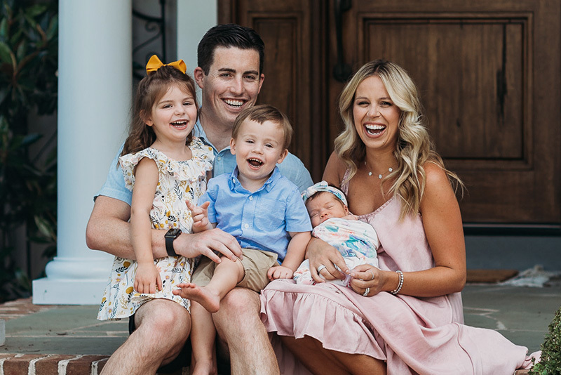 Tyler poses with his parents and two sisters for a family photo.