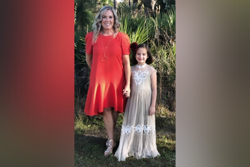 Emma and her mom, wearing fancy dresses