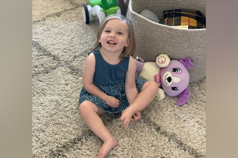 hadley, who had a stroke, sits near a basket of toys