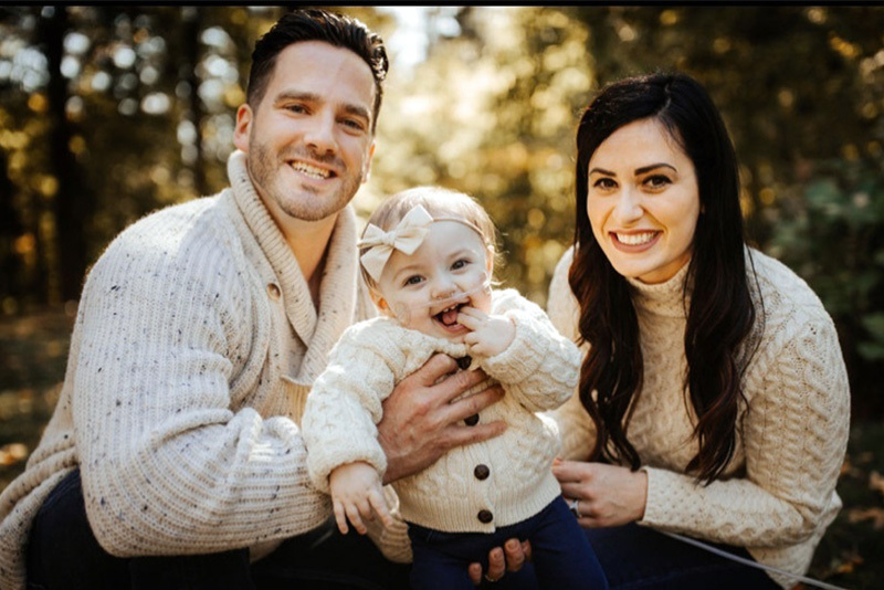 Scarlett, who had CDH, poses with her parents
