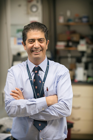Ofer Levy stands smiling in his lab.
